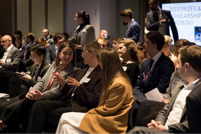 A group of people sitting in a room

AI-generated content may be incorrect.