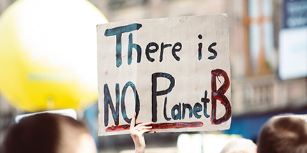 A climate activist holds a placard at a protest