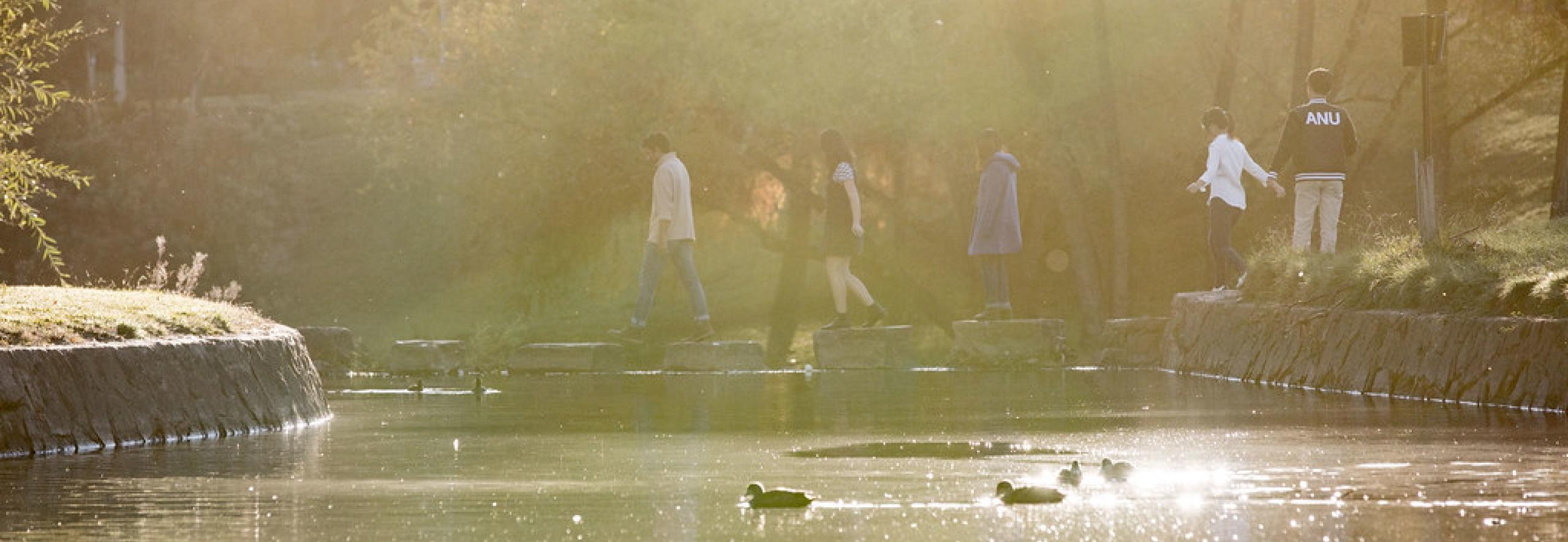 students crossing creek