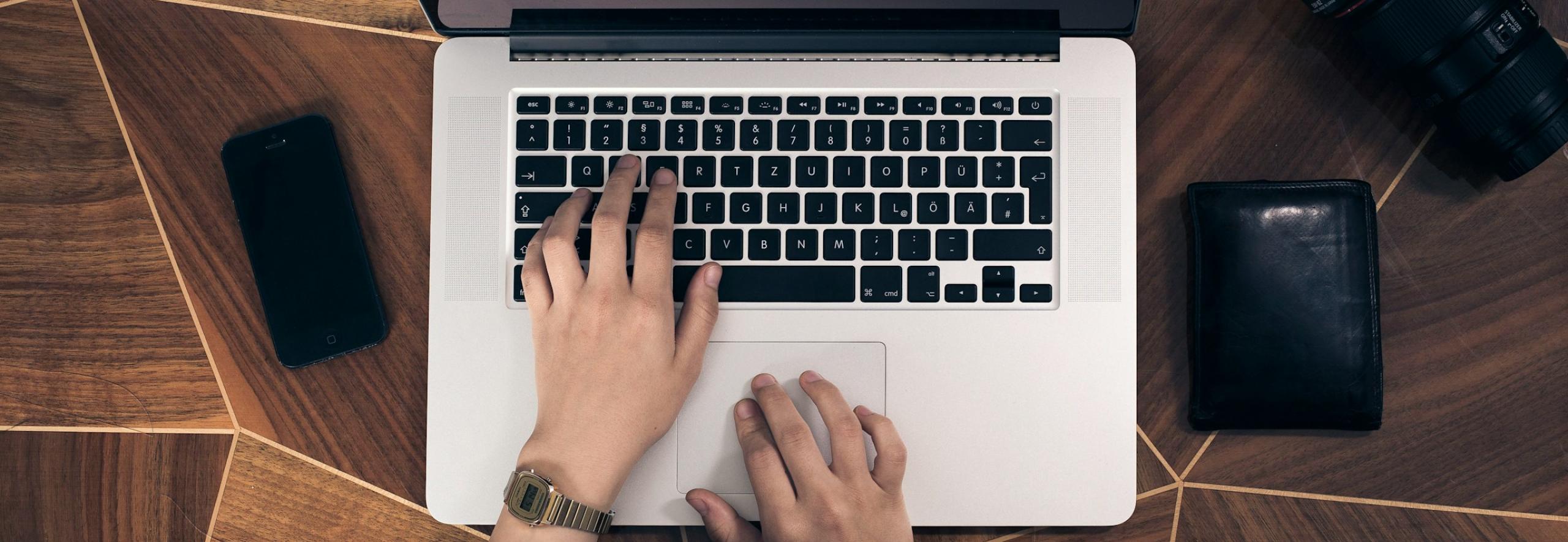Hands on a laptop keyboard
