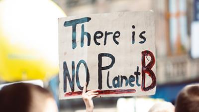 A climate activist holds a placard at a protest